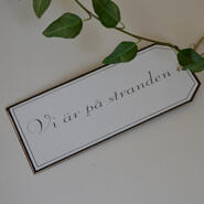 Skylt - Vi är på stranden